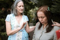 Two women in a peaceful prayer moment, sharing spiritual connection outdoors, emotional intelligence, The Bible