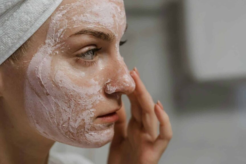 fall skincare - Close-up of a woman applying facial cream as part of her skin care routine, enhancing skin health.