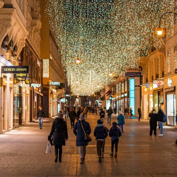 Armani, hotels, Night view of Vienna's bustling street adorned with holiday lights, capturing the festive vibe.