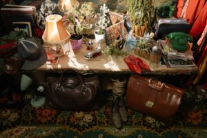 red flags, thrifting, A warm, cluttered secondhand store with vintage items and eclectic antiques on display.