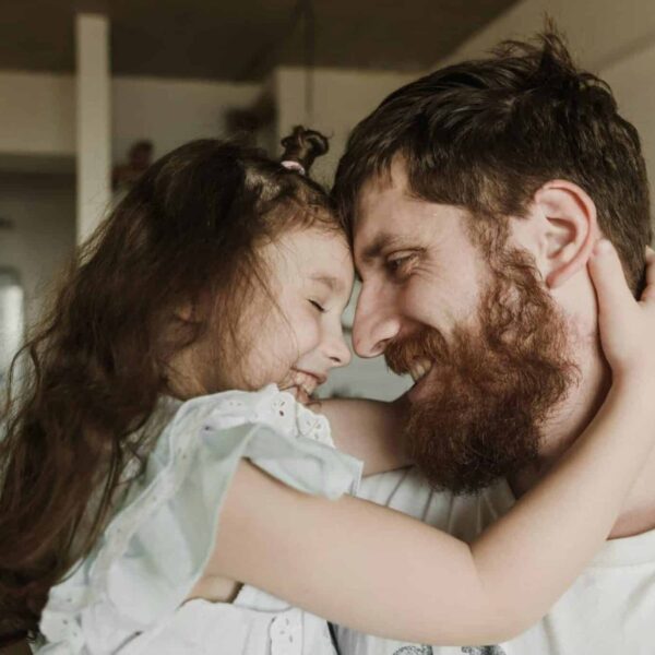 Heartwarming moment of a father and daughter embracing indoors, showcasing love and happiness, Parenting philosophy