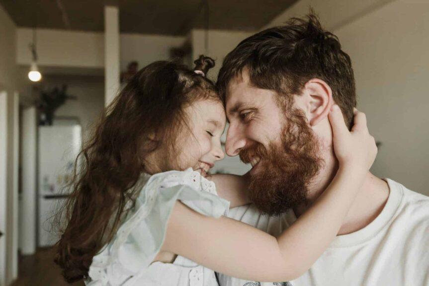 Heartwarming moment of a father and daughter embracing indoors, showcasing love and happiness, Parenting philosophy