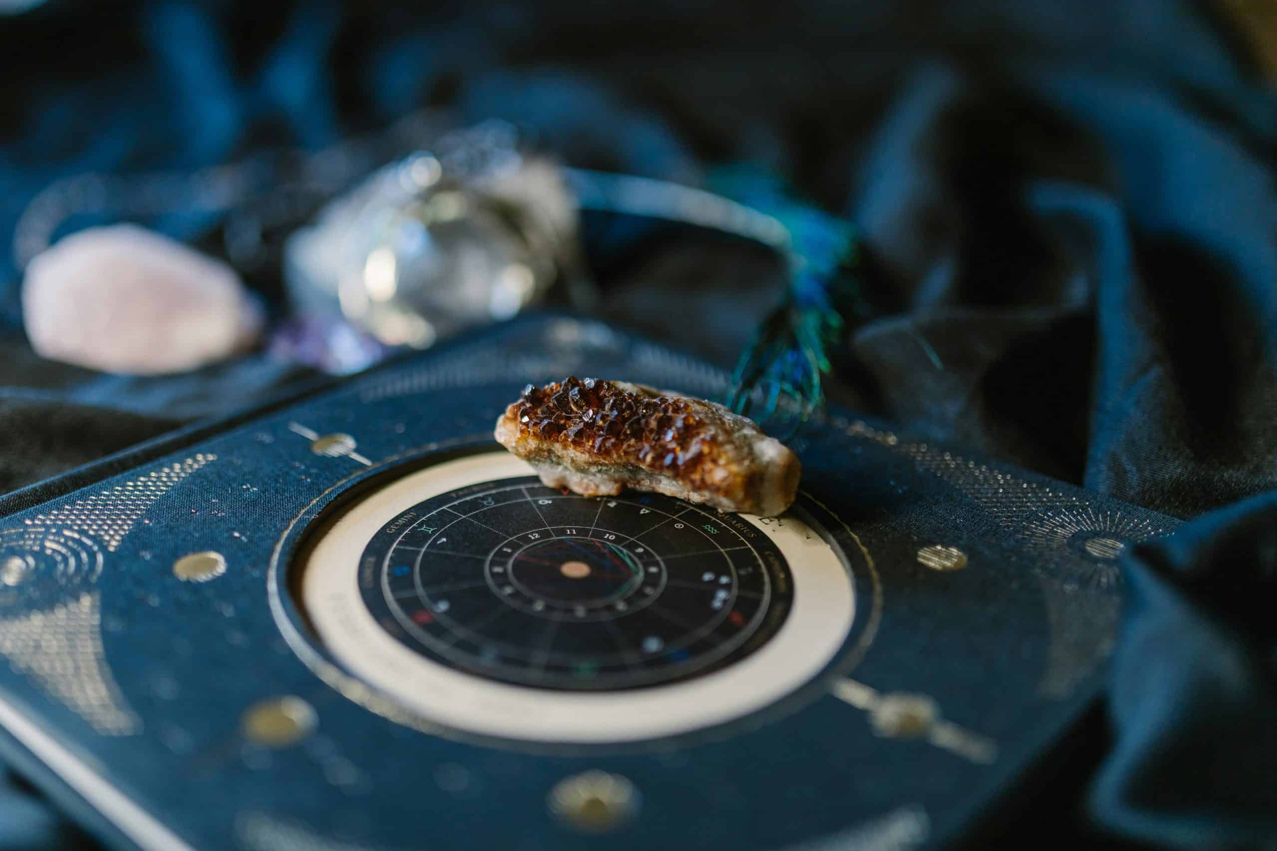 T-Square,Close-up of crystals on an astrology chart atop dark fabric for a mystical vibe.