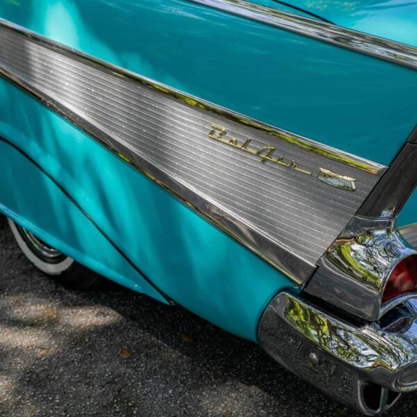 Close-up of a vintage turquoise Chevrolet Bel Air convertible showcasing its retro tail fin design.