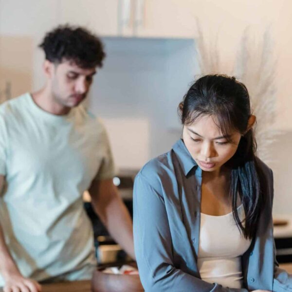 A couple having a serious conversation in a modern kitchen setting. gray rocking