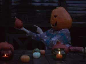 Person wearing a pumpkin head and spooky sweater Photo by Annie Smurova on Unsplash