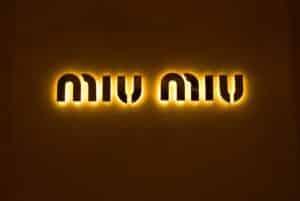 This is a photograph of the Miu Miu logo. The Arcadie handbag is a popular Miu Miu item.