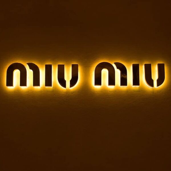 This is a photograph of the Miu Miu logo. The Arcadie handbag is a popular Miu Miu item.