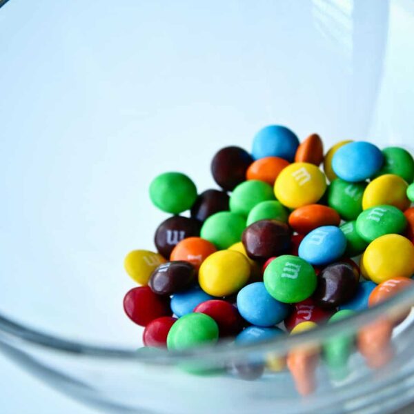 a glass bowl filled with lots of colorful candy. M&M's candy M&M's candy rescue