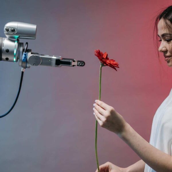 A woman interacts with a robotic arm holding a flower, symbolizing human-technology harmony. relationships with AI,LLM