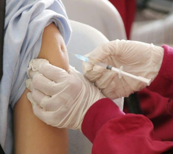 flu vaccine a person in a red shirt and white gloves flu vaccinations, vaccinate