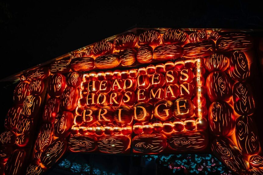 a lit up sign that says, headless horseman bridge Sleepy Hollow New York