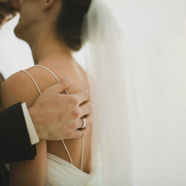 Intimate close-up of a newlywed couple embracing, showcasing love and togetherness, happy marriages