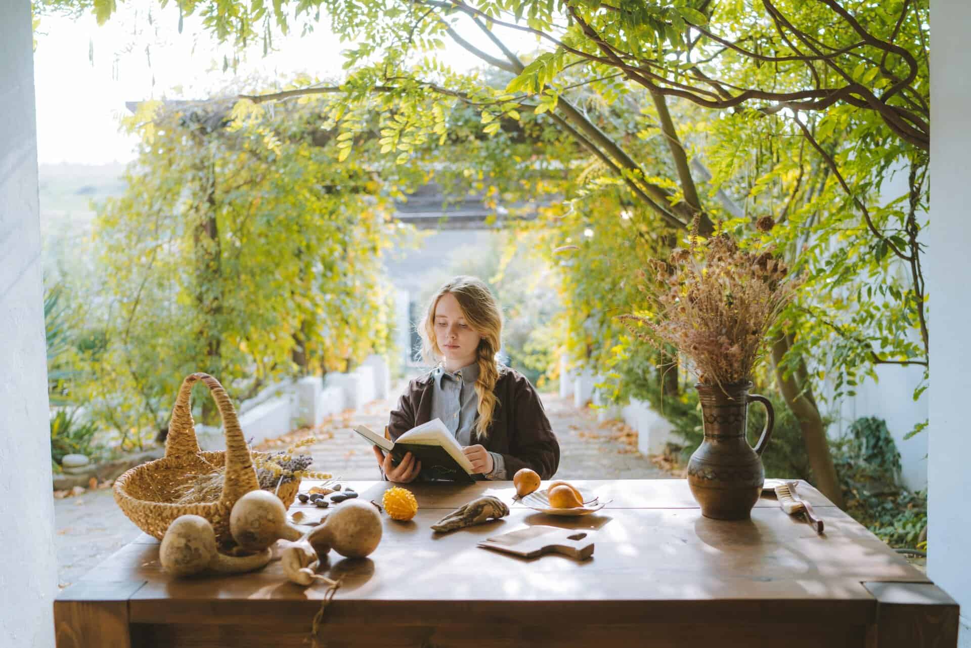 This photograph features a woman embracing autumn as she reads. Beauty products can help you enjoy wonderful autumn moments.