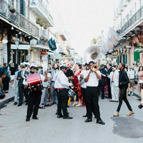 New Orleans, autumn, fall, halloween, travel A lively street parade with musicians and crowds in the heart of New Orleans, capturing the festive spirit of the city.