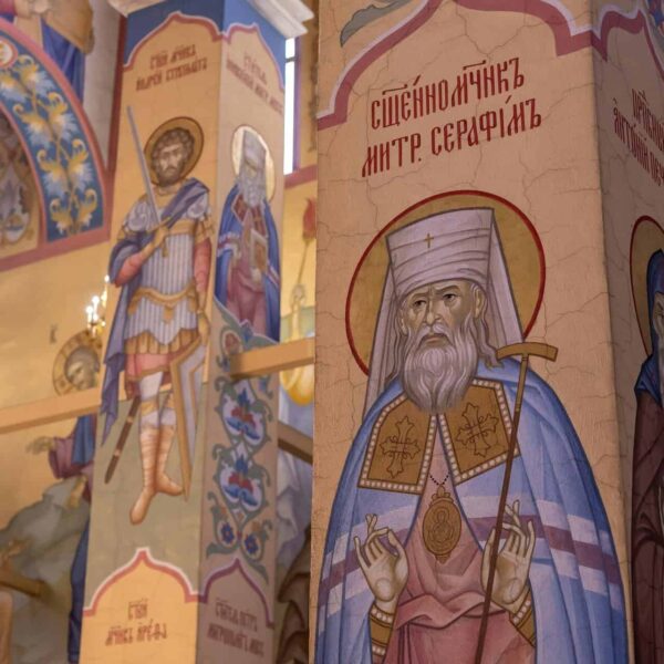 Vibrant frescoes depicting saints in an ornate Orthodox church interior., Saint Seraphim of Sarov