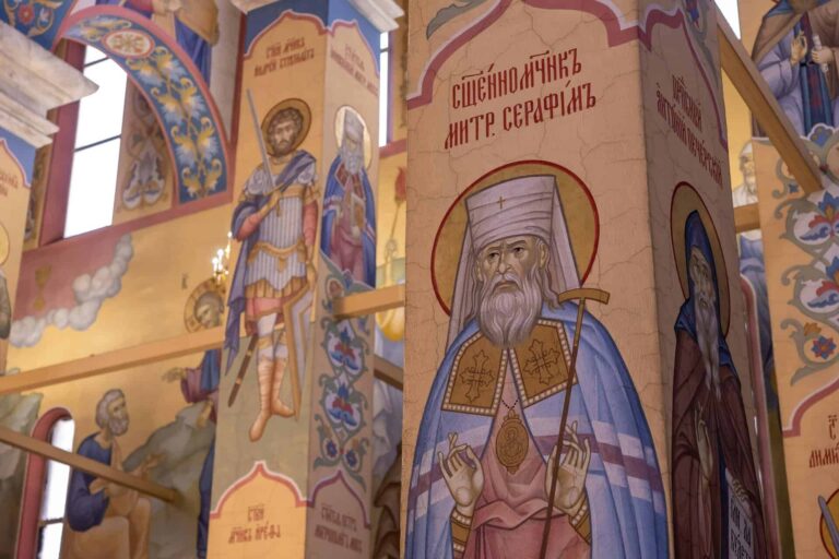 Vibrant frescoes depicting saints in an ornate Orthodox church interior., Saint Seraphim of Sarov