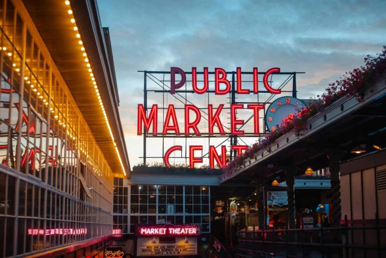 Vibrant Pike Place Market sign in Seattle, captured at dusk with neon lights glowing. Autumn.
