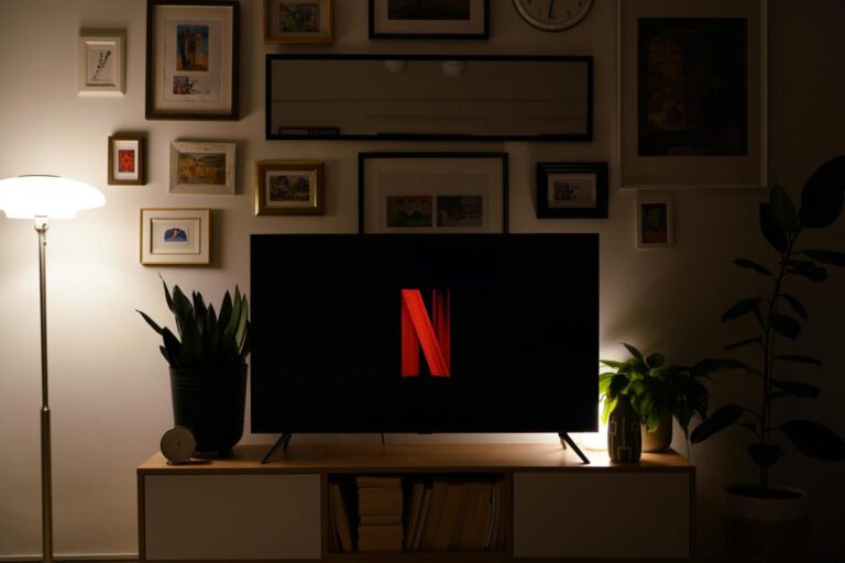 Modern living room with TV featuring a prominent logo, stylish decor and ambient lighting. Netflix, Korean Shows