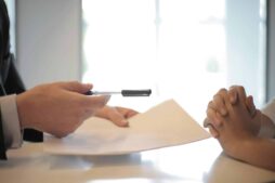 Close-up of a contract signing with hands over documents. Professional business interaction. lawyer