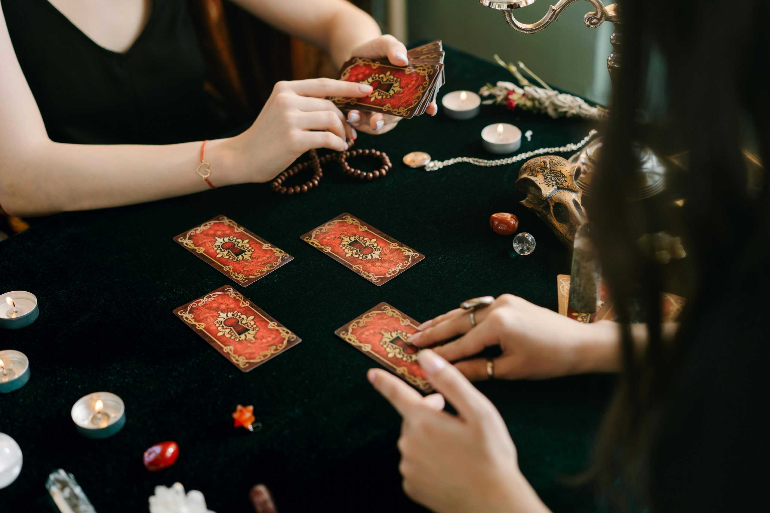 A tarot card reading session with crystals and candles, creating a mystical atmosphere. 