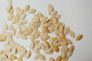 This is a photograph of pumpkin seeds. A pumpkin seed addition can be great in a fall recipe.