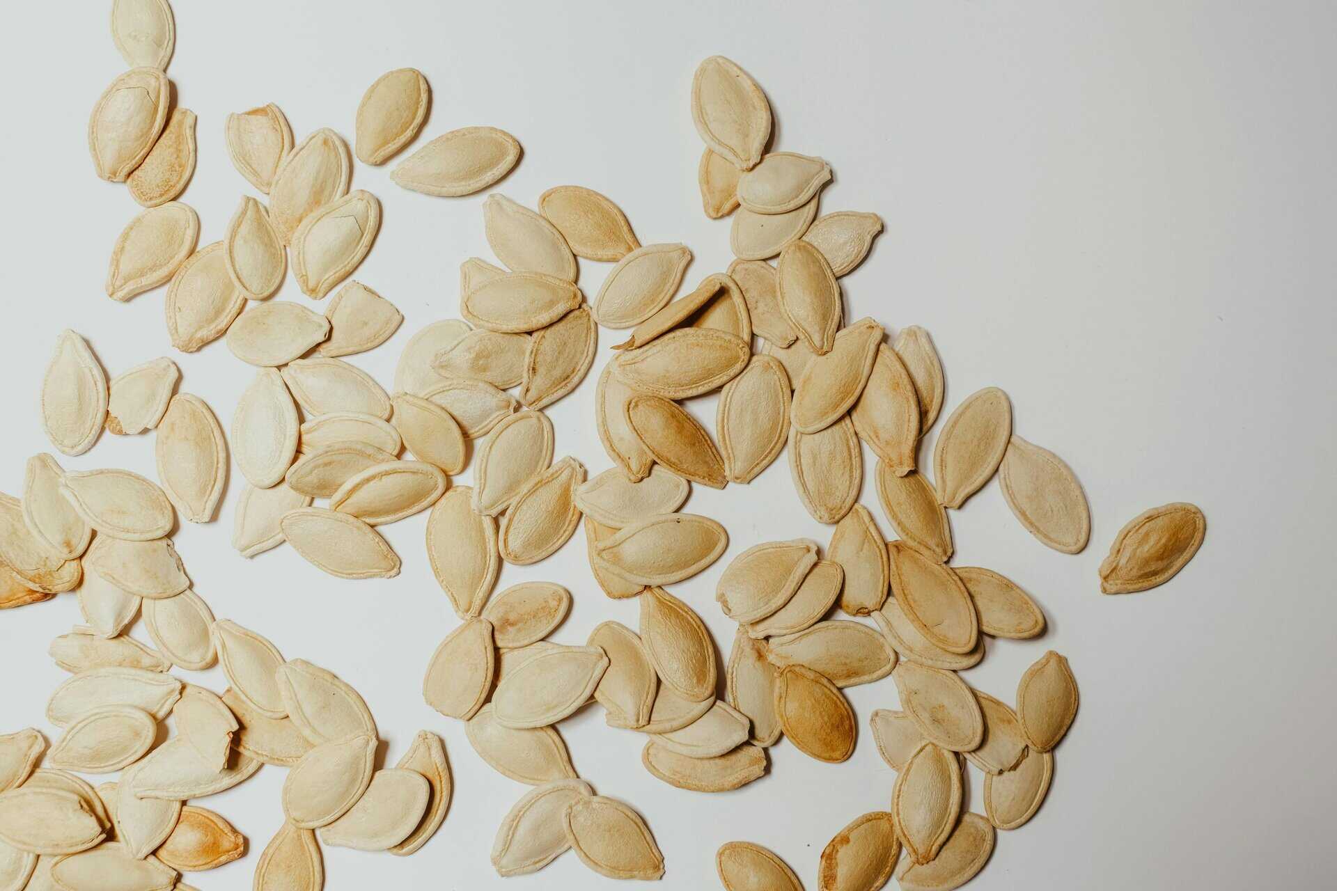 This is a photograph of pumpkin seeds. A pumpkin seed addition can be great in a fall recipe.