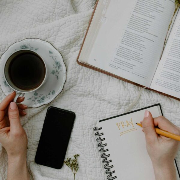 A serene morning meditation scene with coffee, Bible, and journal, daily devotion
