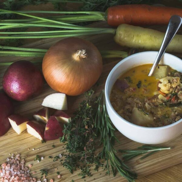 A homemade root vegetable soup with fresh ingredients, perfect for a cozy dinner. Fall foods for gut health.