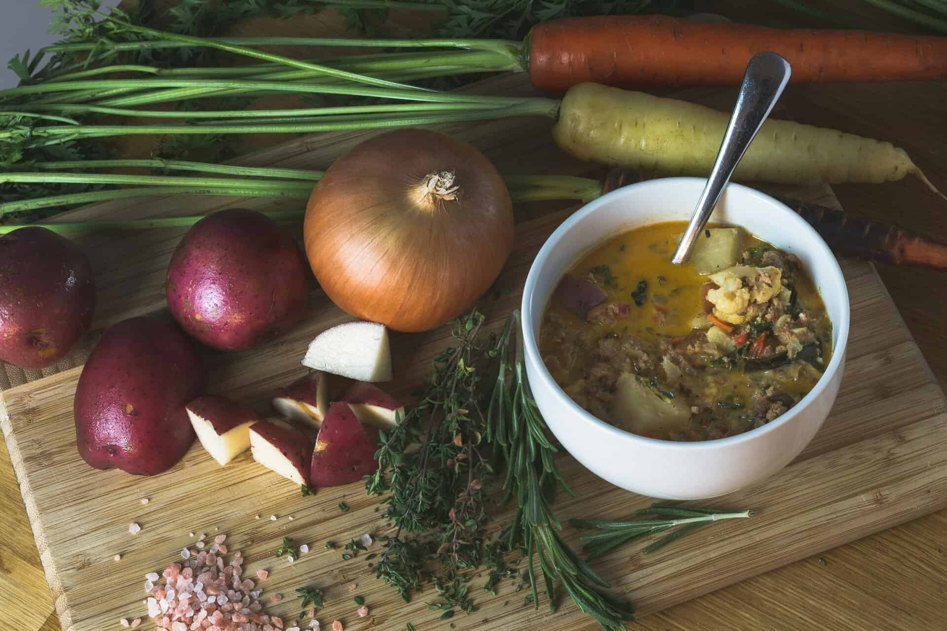 A homemade root vegetable soup with fresh ingredients, perfect for a cozy dinner. Fall foods for gut health.