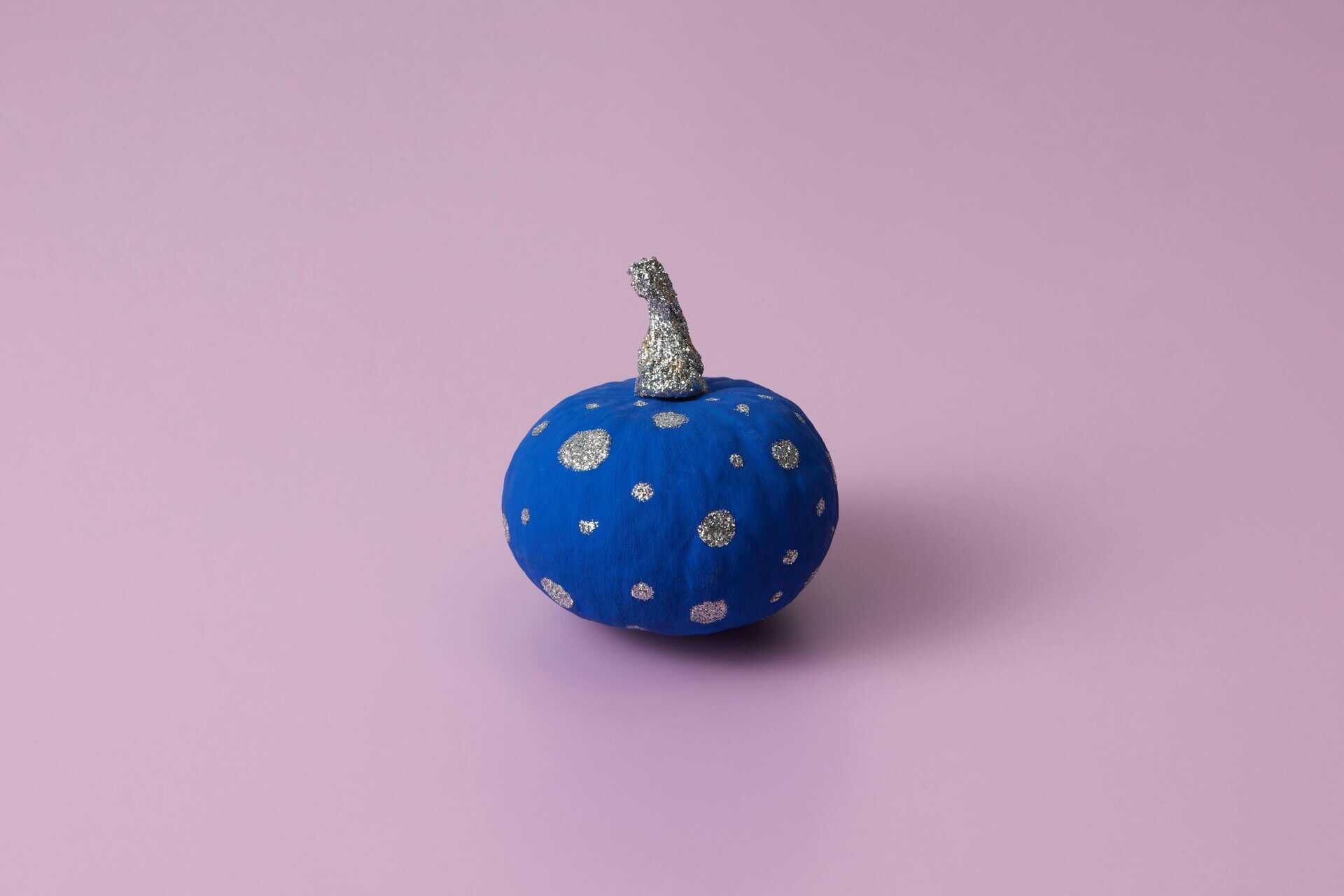 This is a photograph of a pumpkin painted blue and silver. You can apply no-carve design strategies to your pumpkins.
