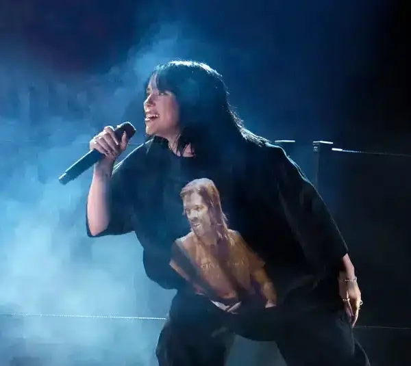 Apr 3, 2022; Las Vegas, NV, USA; Finneas (l) and Billie Eilish perform Happier Than Ever during the 64th Annual Grammy Awards at the MGM Grand Garden Arena in Las Vegas. EIlish is wearing a shirt featuring an image of Foo Fighters drummer Taylor Hawkins. Mandatory Credit: Robert Hanashiro-USA TODAY. Eilish will work with James Cameron on her next 3D project.