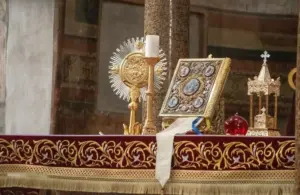 Roman Catholic church altar in Rome, Italy topped with bible and religious items, Saint Aloysius de Gonzaga, Saint Syncletica