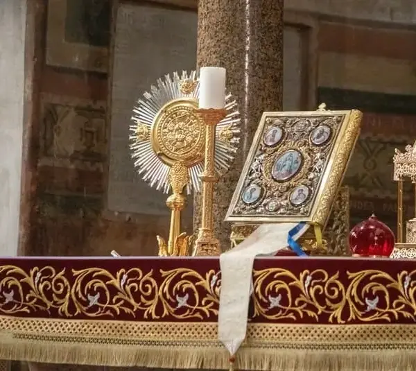 Roman Catholic church altar in Rome, Italy topped with bible and religious items, Saint Aloysius de Gonzaga, Saint Syncletica