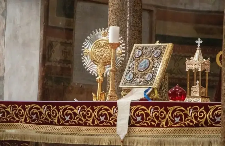 Roman Catholic church altar in Rome, Italy topped with bible and religious items, Saint Aloysius de Gonzaga