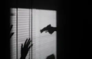 silhouette of person held at gunpoint / Girlalala