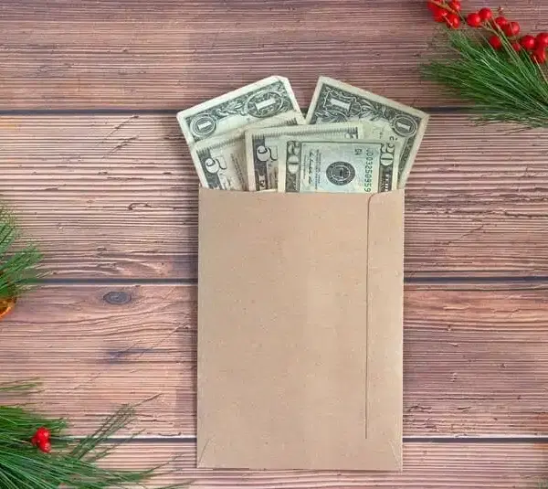 Envelope of money on a table with winter decoration, mental health, money stress