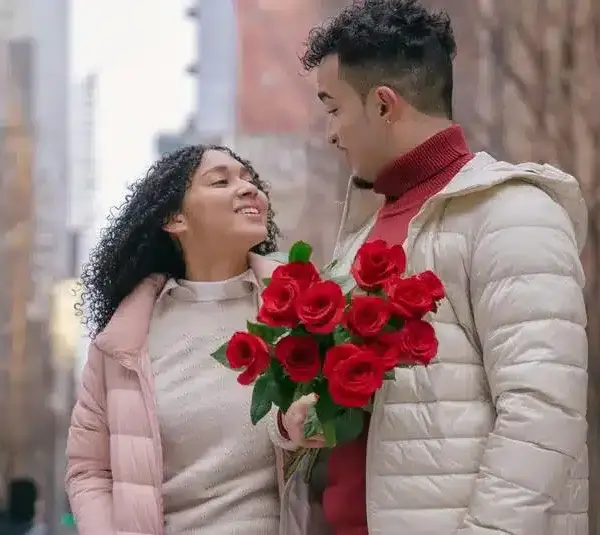 couple together holding roses. winter date ideas