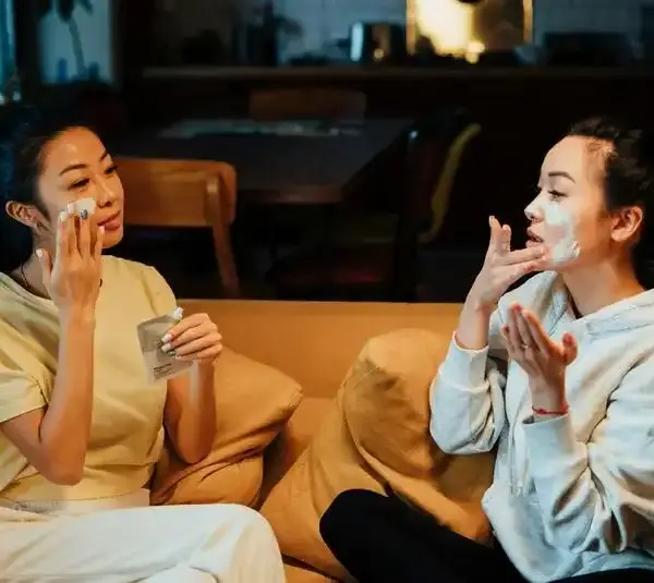 Two women trying K-beauty and beauty trends