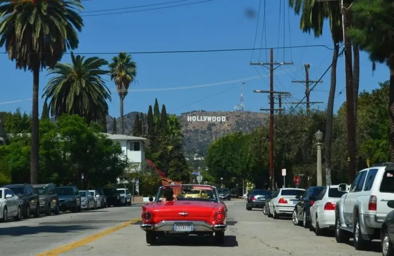 Red car traveling in Hollywood, where AFM is located.