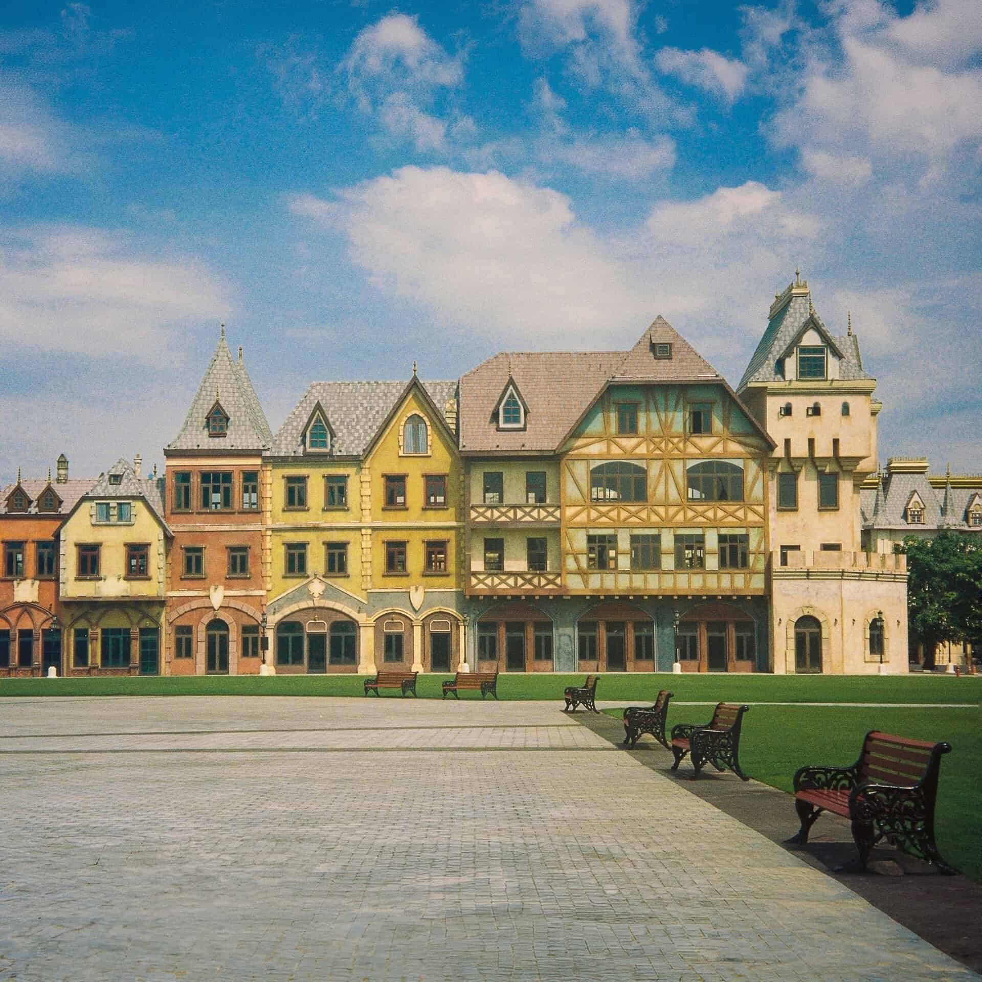Scenic view of colorful European-style buildings lining a plaza on a clear day in Phu Quoc, Vietnam.