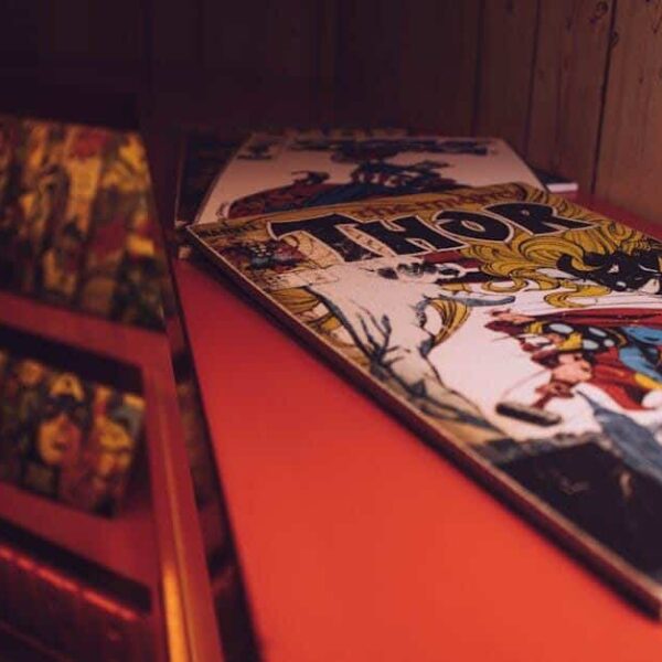 Close-up of a vintage Thor comic book displayed in an art gallery or store. Top Comics