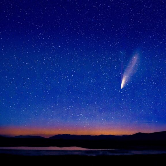 Dramatic view of a comet streaking across a starry night sky over Montana landscape. The top of Expedia's destinations of the year.