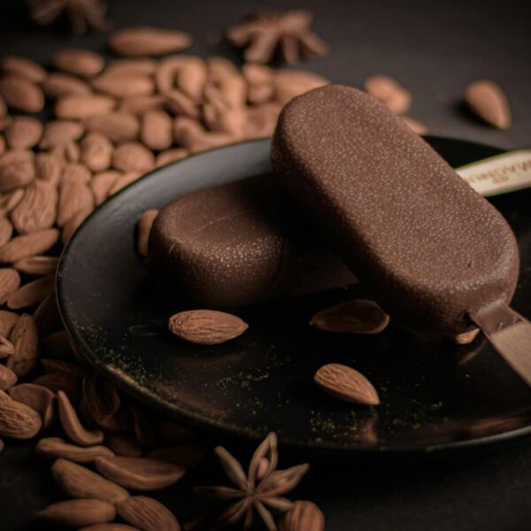 Rich almond and chocolate ice cream bars on a dark plate with whole almonds. Häagen-Dazs, recall on ice cream bars.