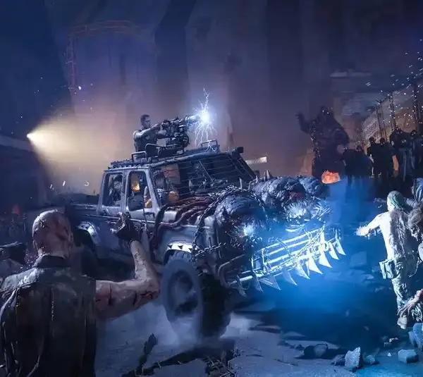Call of Duty: Black Ops 7 Zombies. A rugged, armored truck plows through a swarm of zombies in a dark, chaotic setting. A man atop fires a mounted gun, spotlight highlighting the scene.