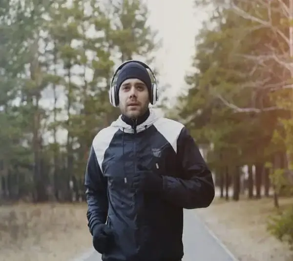 Man running outdoors in winter, winter fitness