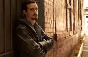 James Ransone standing against a wall in "Low Winter Sun" (2013)