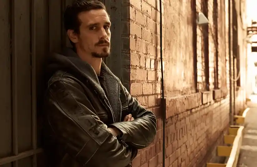 James Ransone standing against a wall in "Low Winter Sun" (2013)