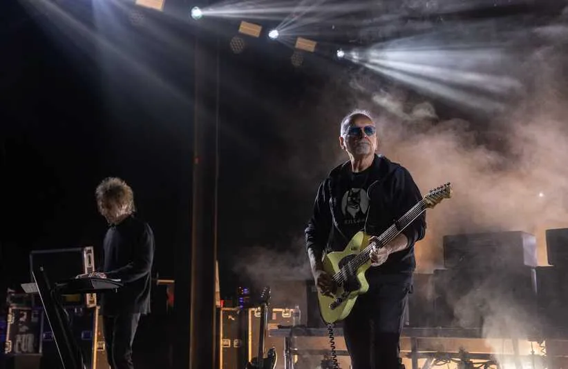 The Cure's Perry Bamonte, left, and Reeves Gabrels perform in front of thousands of people at the Pine Knob Music Theater in Clarkston on Tuesday, June 13, 2023. Perry Bamonte has passed away.