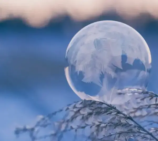Winter solstice, frozen sphere with winter background